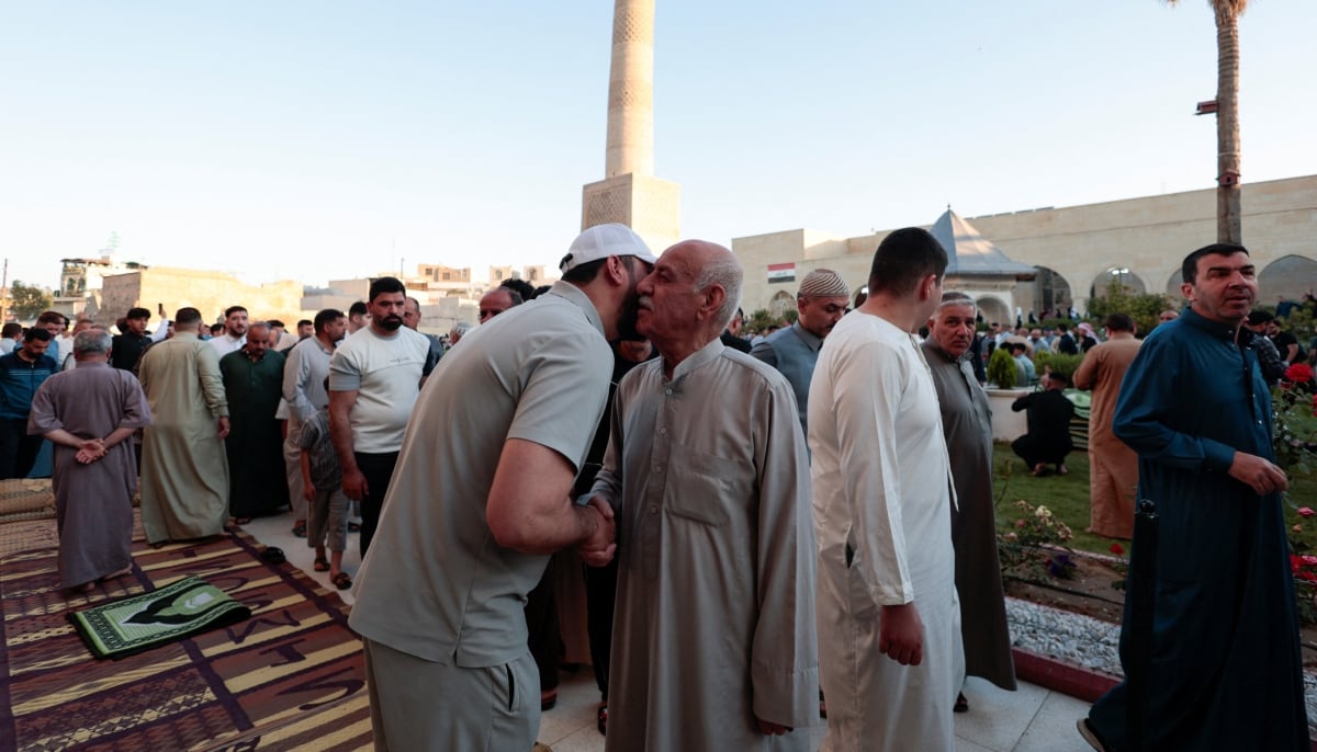 Muslims exchange greetings after Eid ul Adha prayers in Mosul, Iraq, May 27, 2026. — Reuters