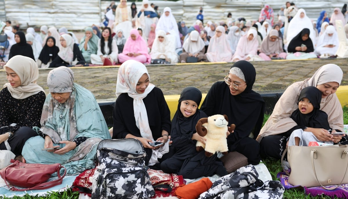 A girl holds a doll as she attends Eid ul Adha mass prayers at the Al Azhar Grand Mosque in Jakarta, Indonesia, May 27, 2026. — Reuters