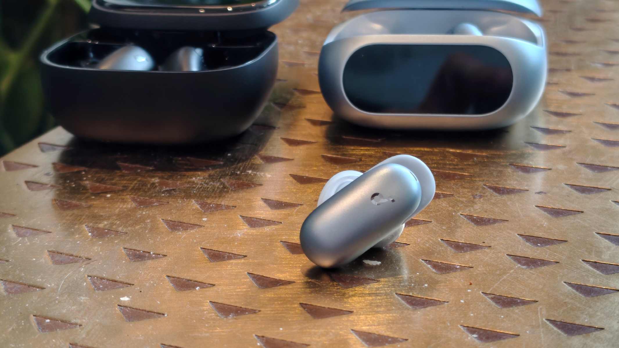The Anker Soundcore Liberty 5 Pro earphone next to the case and the Anker Soundcore Liberty 5 Pro Max.