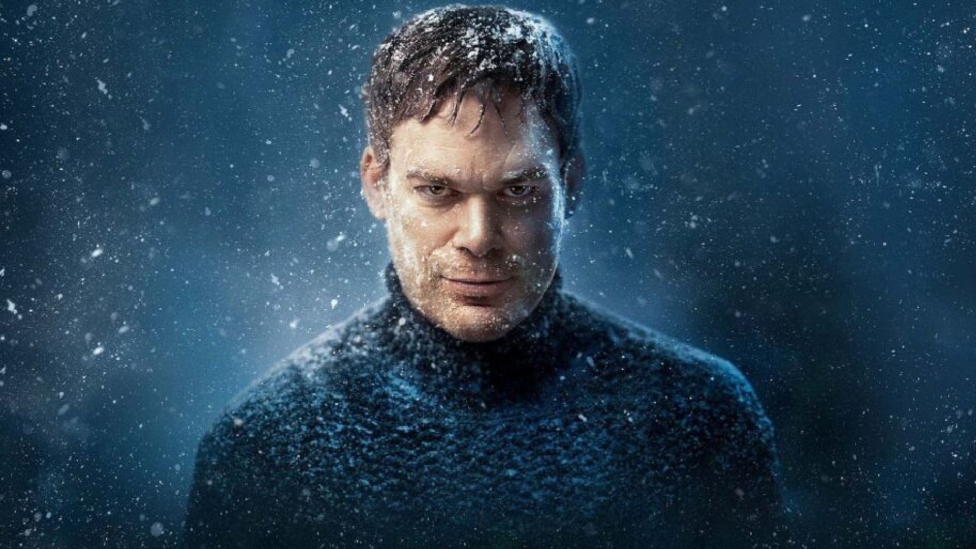 Dexter wears a navy knit turtleneck that starts right down the lens covered in snow