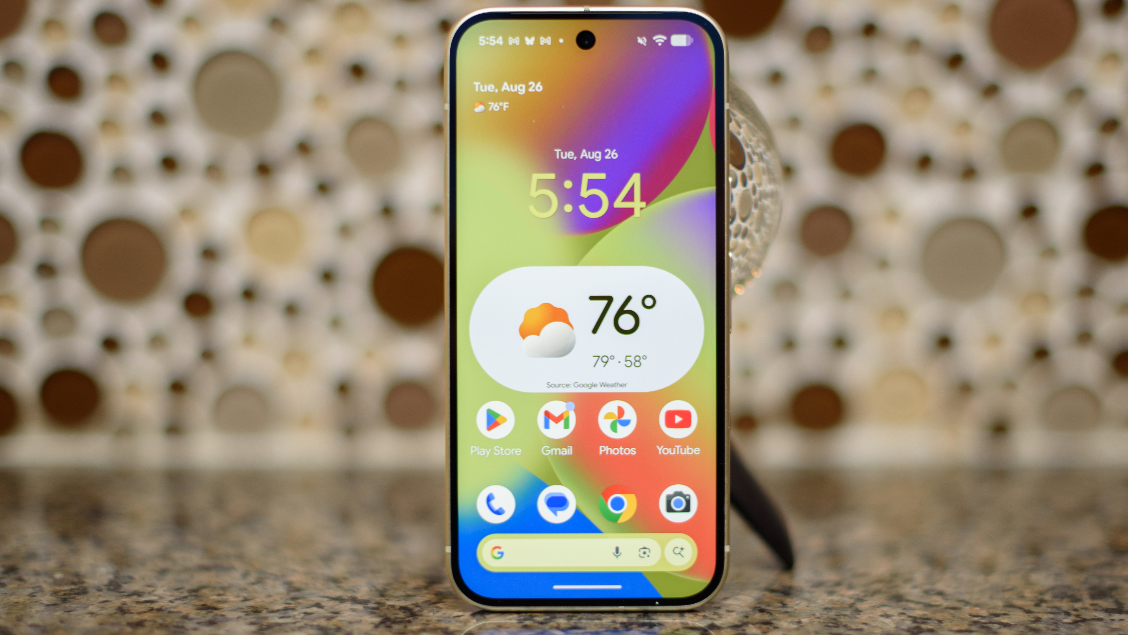 Google Pixel 10 in lemongrass against a bubbling backlash