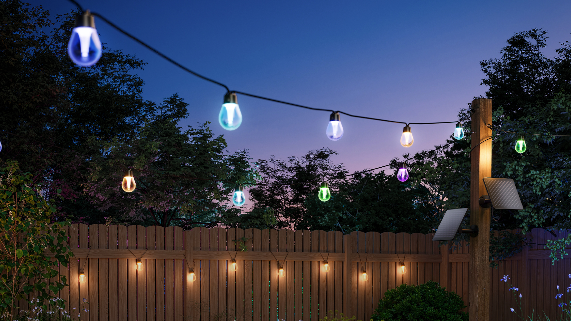 Govee Outdoor Solar String Lights suspended from a line and hanging on a fence at dusk