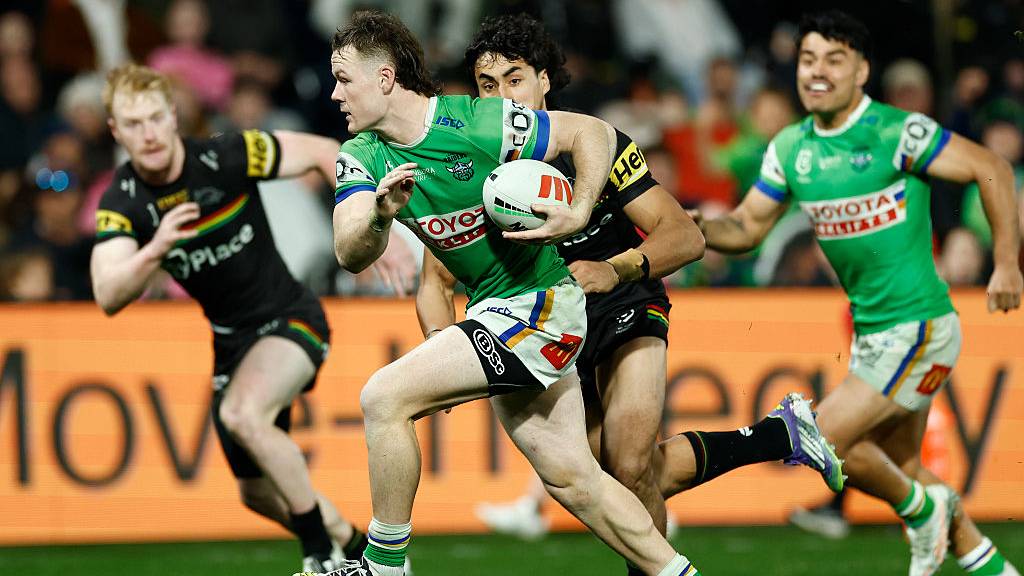 Ethan Strange of the Canberra Raiders runs away from the Penrith Panthers defense in NRL 2025