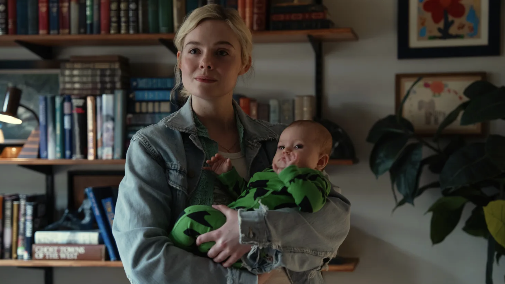 Elle Fanning as Margo Millet, holding baby Bodhi