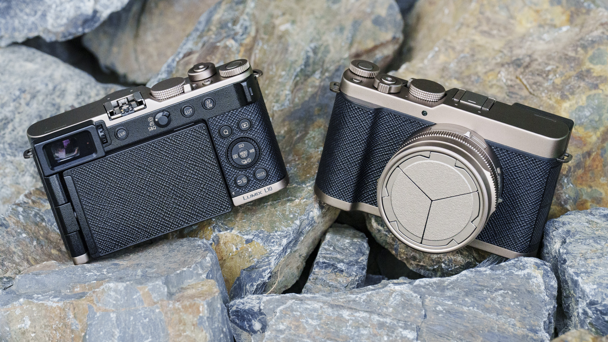 Gold Titanium Special Edition of the Panasonic Lumix L10 compact camera, sitting on gray and rust colored stones