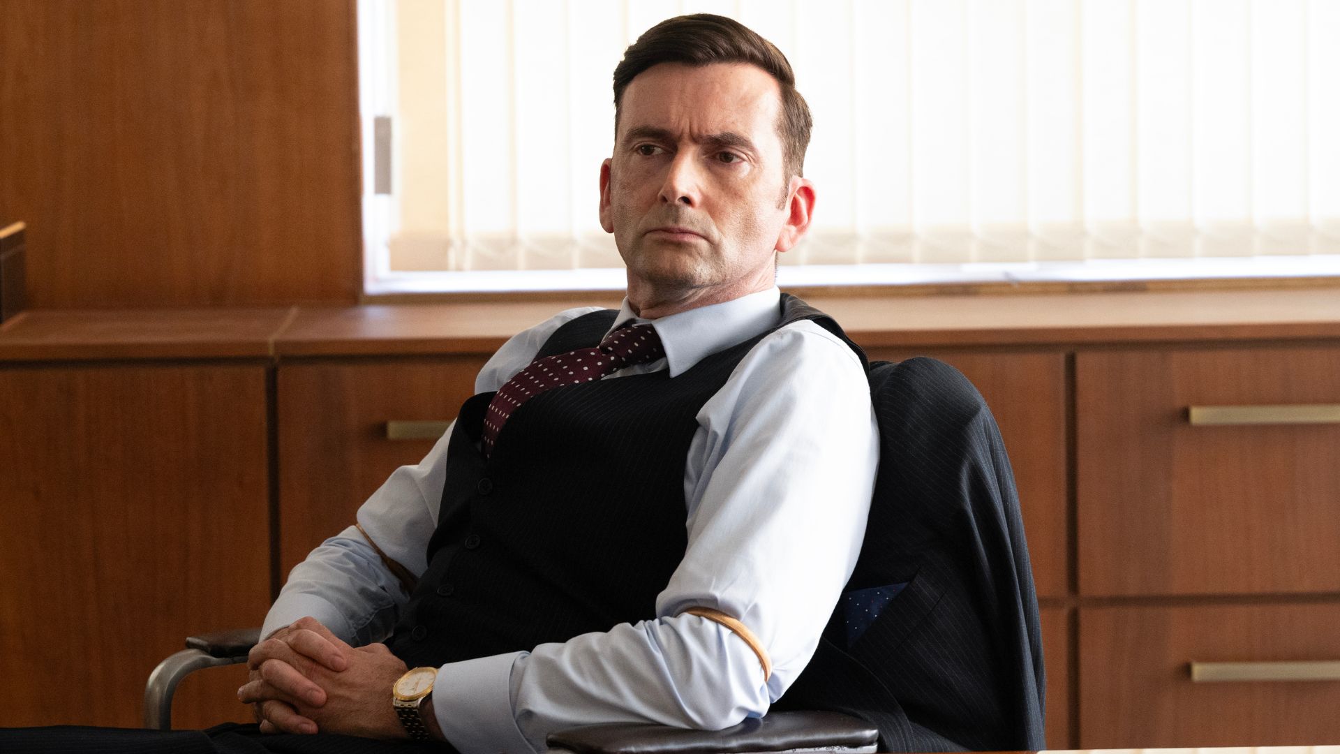 Tony Baddingham is sitting at his desk