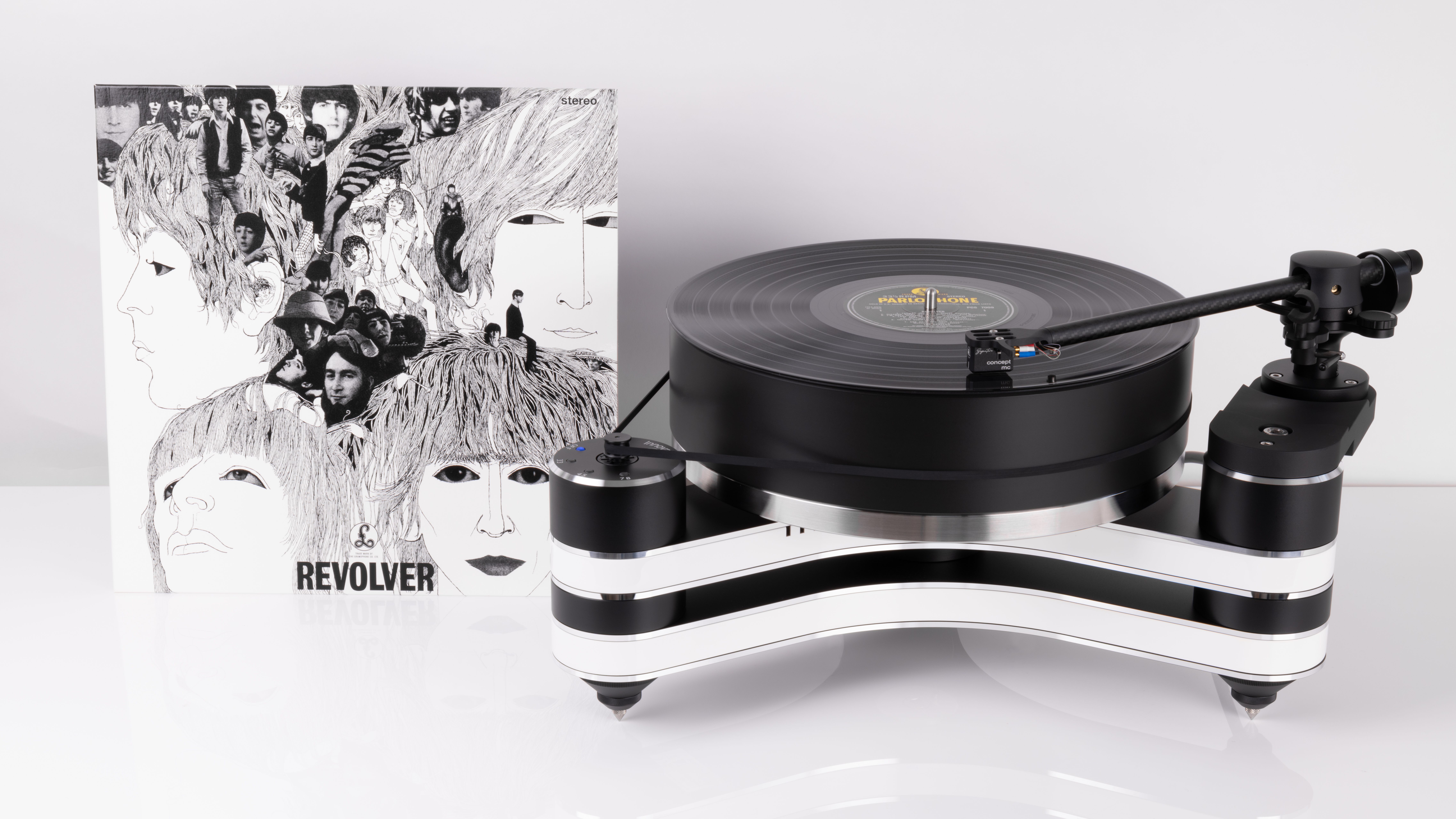 Clearaudio's Innovation Revolver Beatles tribute turntable, with the vinyl album in-shot, on a white background