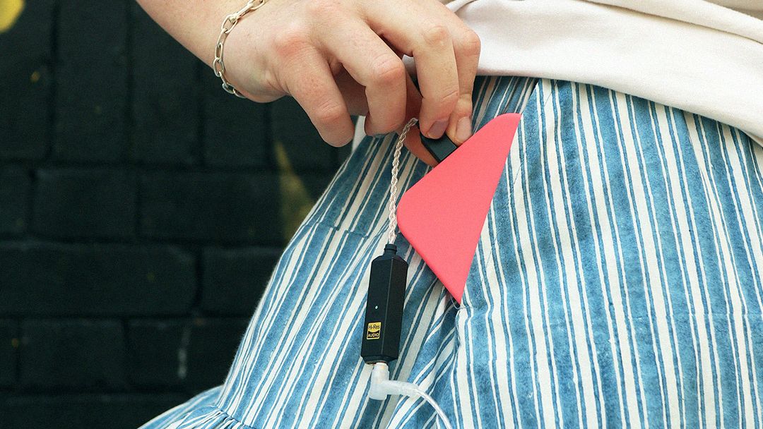 iFi Go Link 2 Max emerges from a woman's pocket with a phone attached