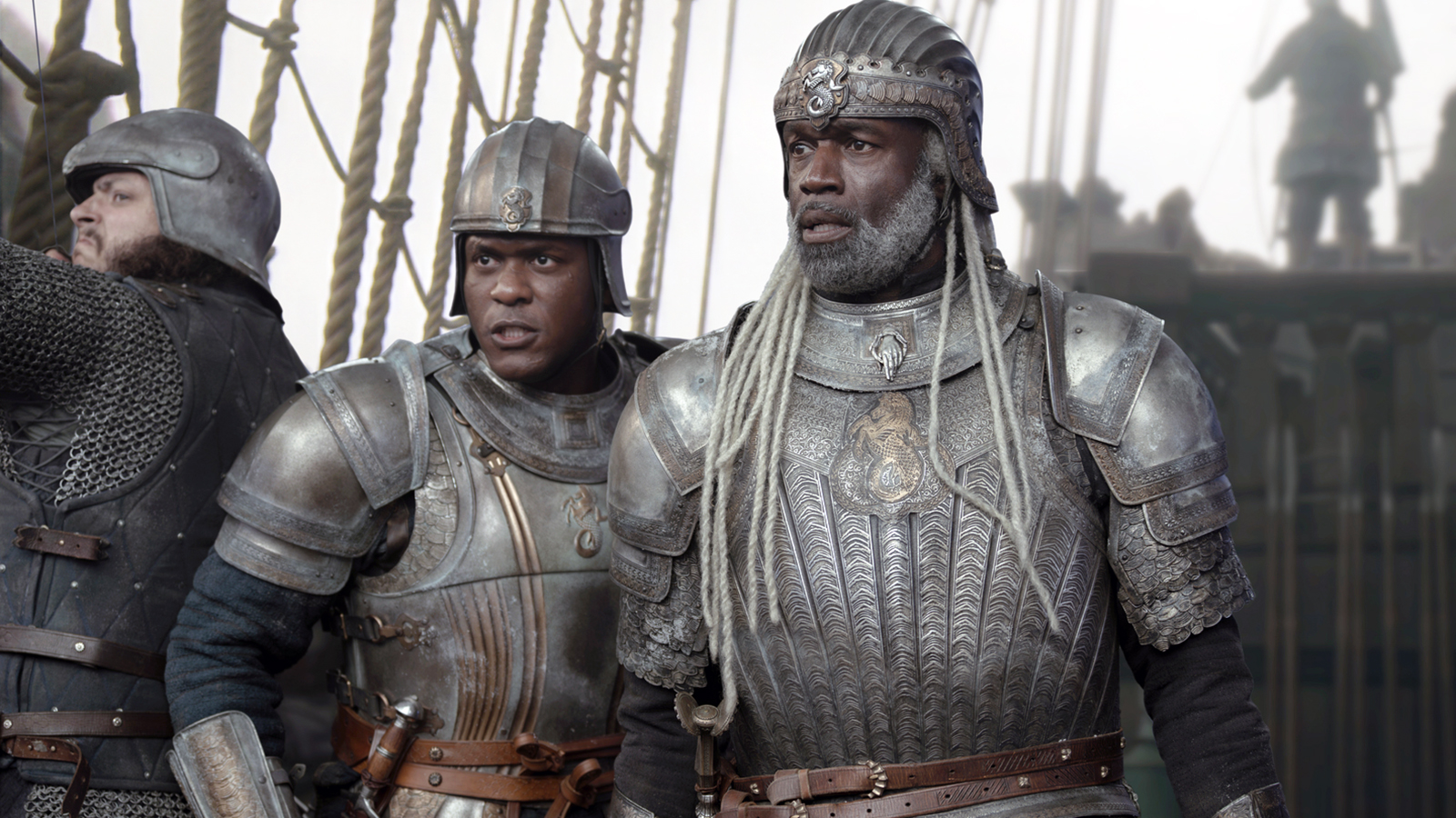 Alyn and Corlys stare at something off camera while standing on the deck of a ship in House of the Dragon Season 3 Episode 1