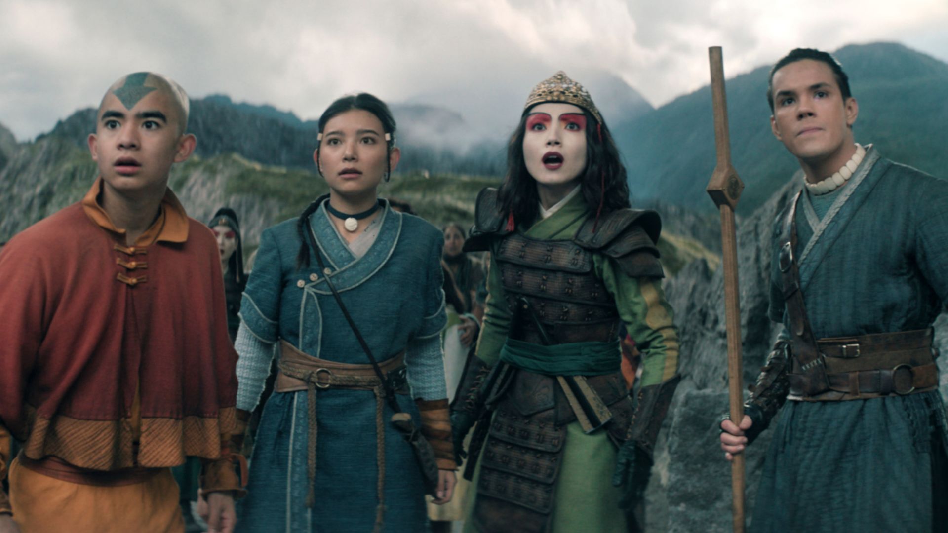 Aang and his friends are standing in front of a mountain