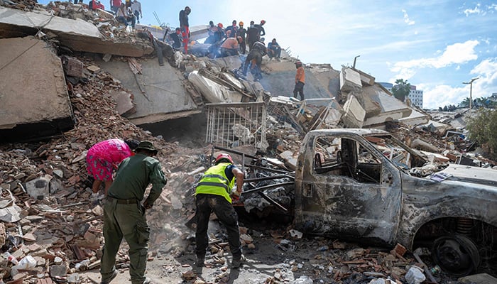 Rescuers and volunteers search for survivors on the rubble of a collapsed building in the state of La Guaira, Venezuela, on June 28, 2026, after an earthquake. — AFP