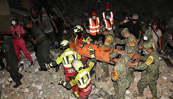 A handout photo released by the Mexican army shows the rescue of a nine-year-old boy in an area hit by two earthquakes in the state of La Guaira, Venezuela, on June 28, 2026. — AFP
