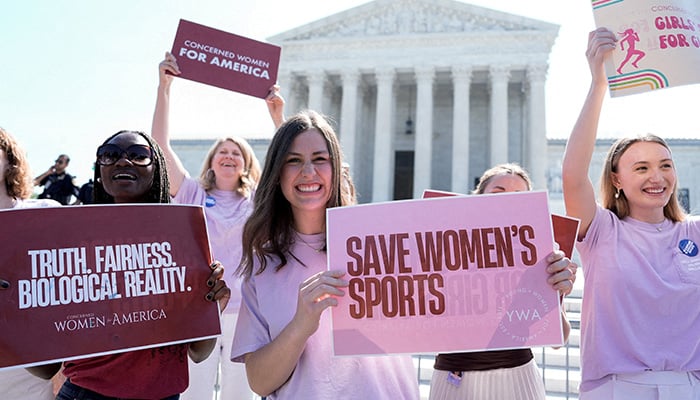 Women hold placards as they celebrate the U.S. Supreme Court's final decisions in its nine-month term, including a decision that cleared the way for states to impose restrictions on transgender student athletes, in Washington, DC, U.S., June 30, 2026. — Reuters