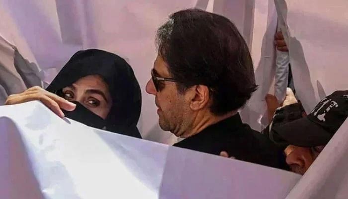 PTI founder Imran Khan with his wife Bushra Bibi arrive to appear in a Lahore High Court on May 15, 2023. — AFP