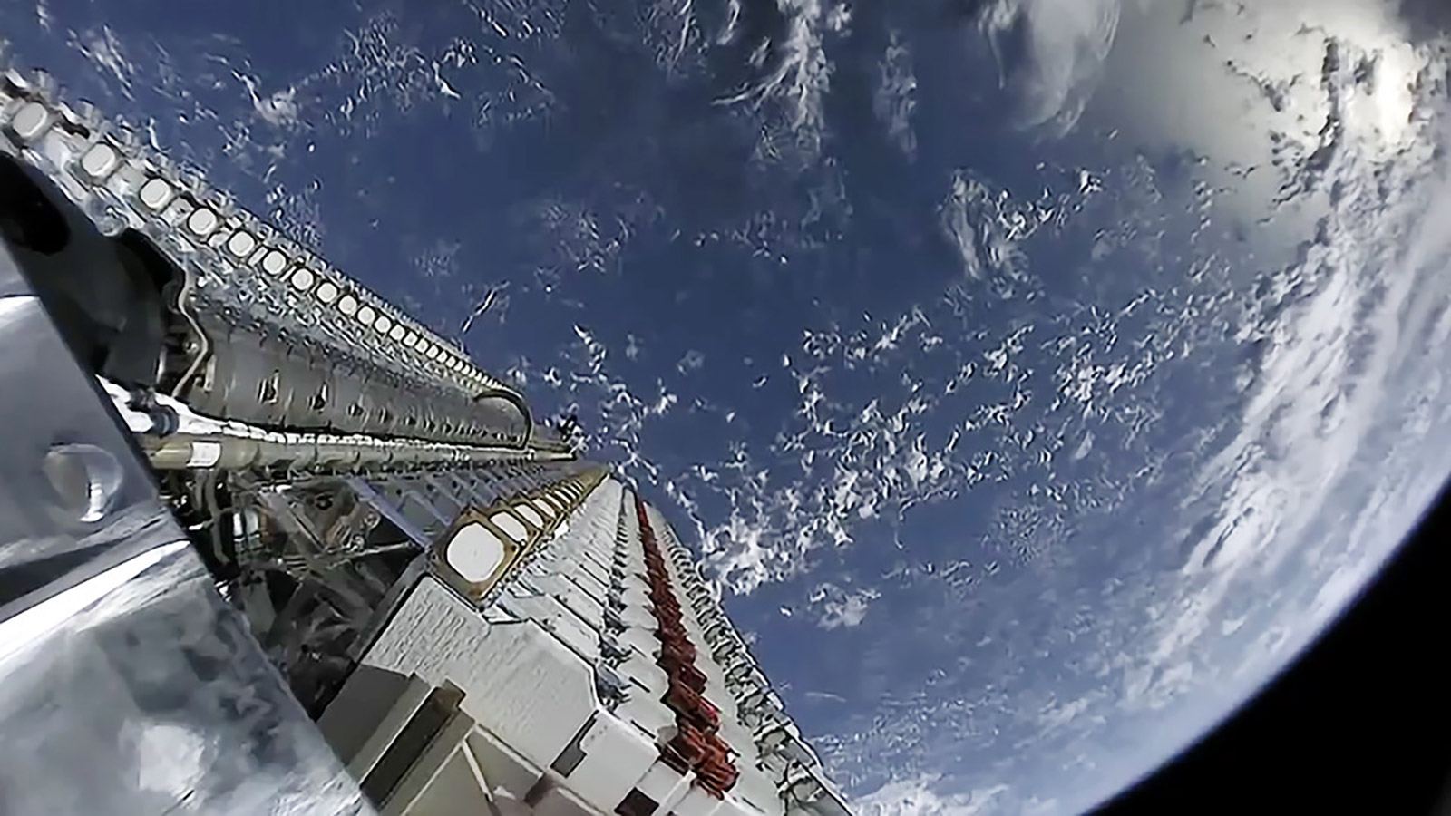 SpaceX Starlink satellites waiting to be released into orbit with Earth in the background