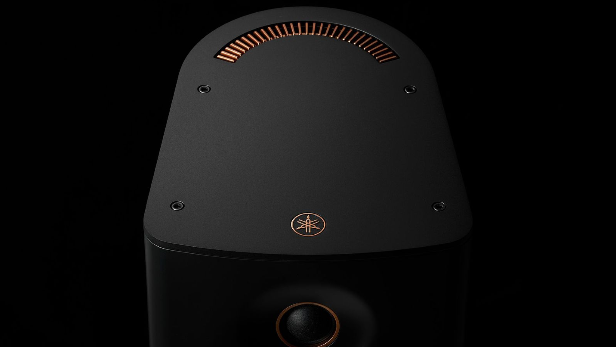 Close-up of the Yamaha NX-70A speaker in black, against a black background
