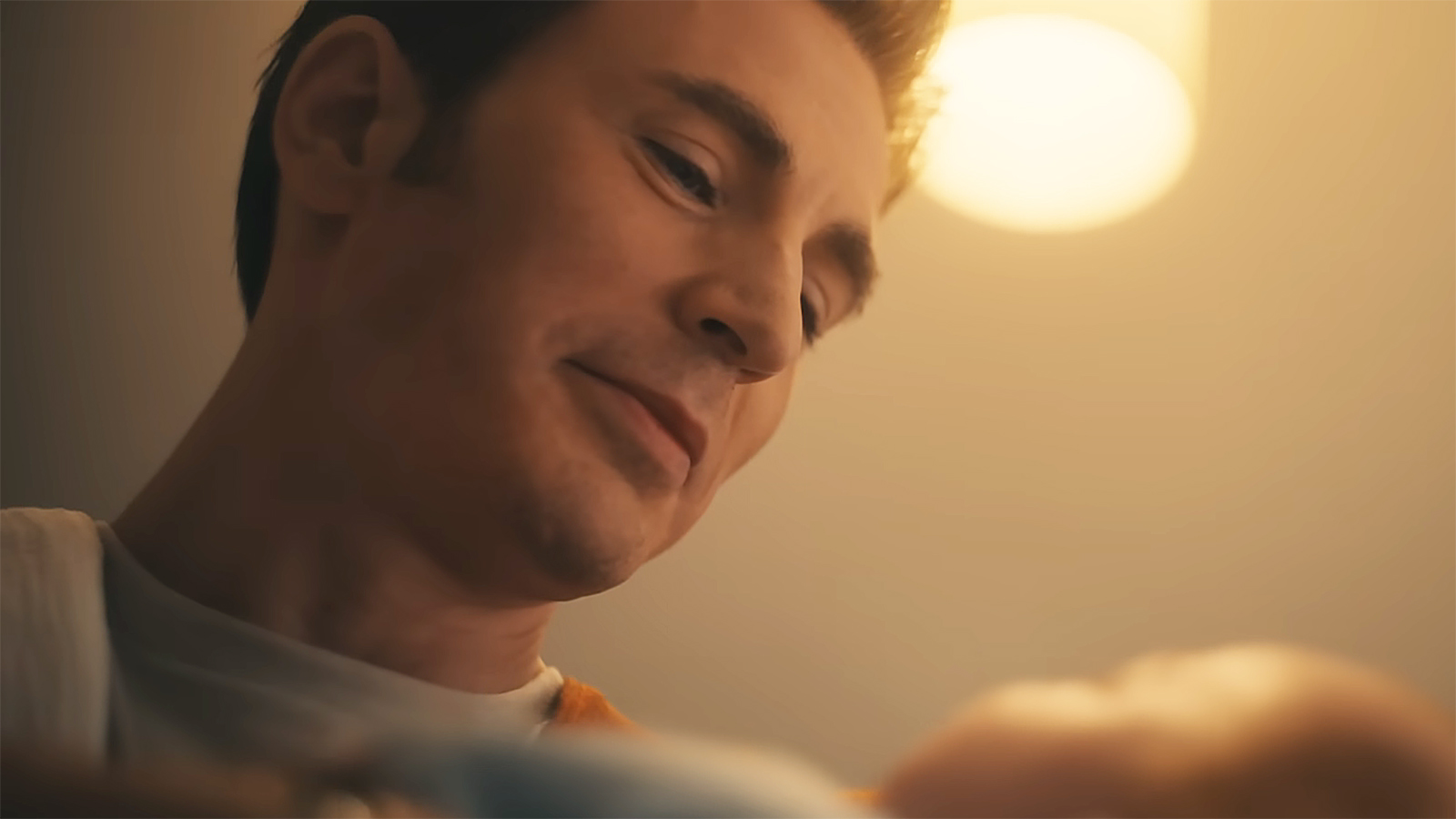 Steve Rogers smiles as he looks down as his newborn son in Avengers: Doomsday
