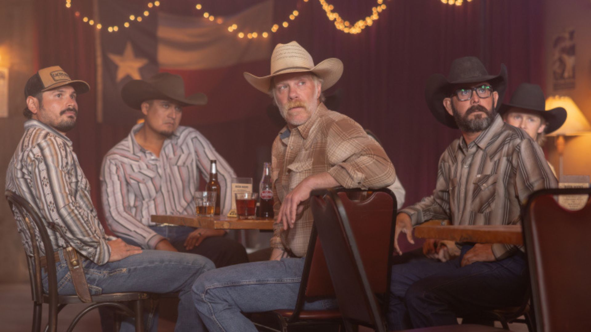 A group of ranchers turn to look at something