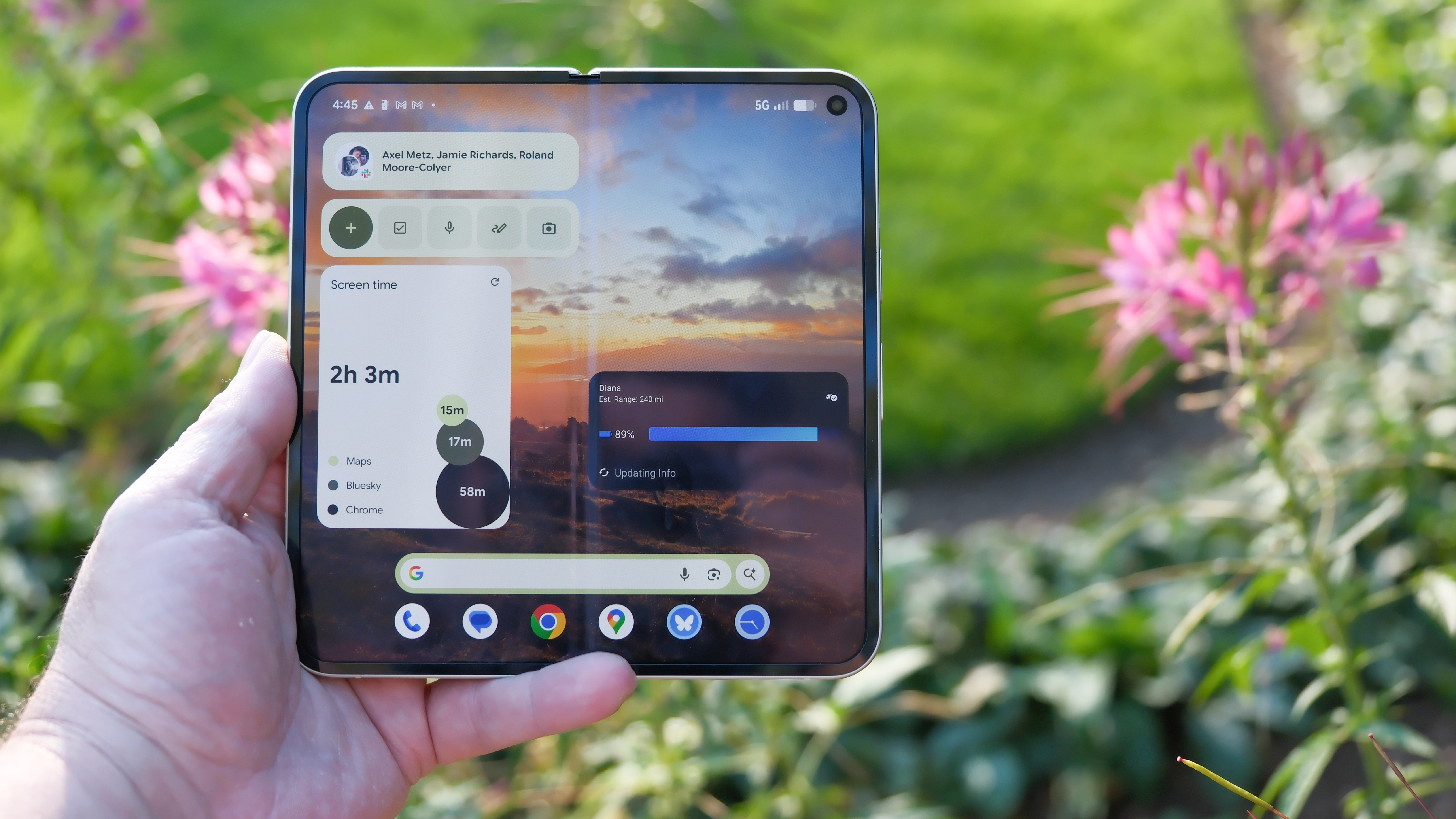Google Pixel 10 Pro Fold in Jade Green outside in a flower garden on a sunny day