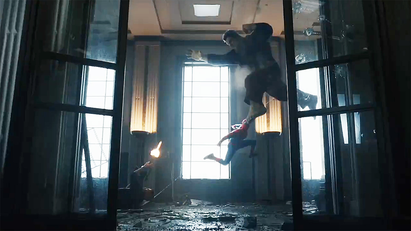 The Punisher lies on the floor as he fires a shot at an airborne Hulk that Spider-Man jumps on in Spider-Man: Brand New Day