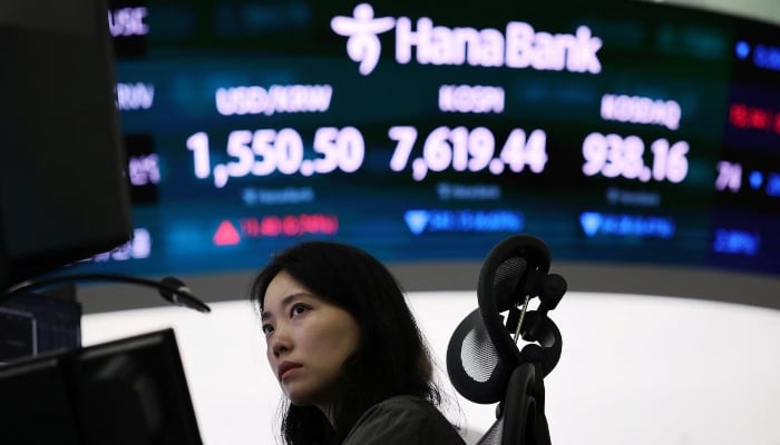 A currency trader works in front of an electronic board showing the exchange rate between the US dollar and the South Korean won, the Korea Composite Stock Price Index (KOSPI) and the South Korean won and the Korea Securities Dealers Automated Quotations (KOSDAQ) in the trading room of a bank in Seoul, South Korea, June 8, 2026. — Reuters