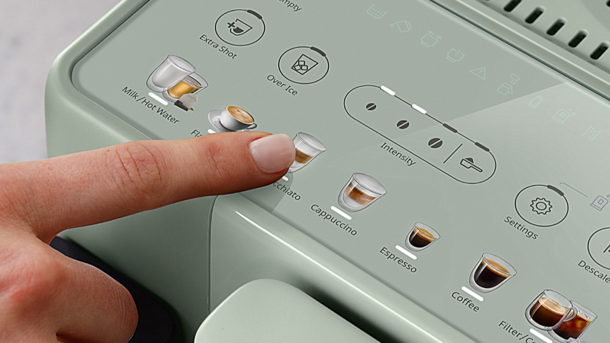 Person pressing button on De'Longhi Rivelia Start coffee machine