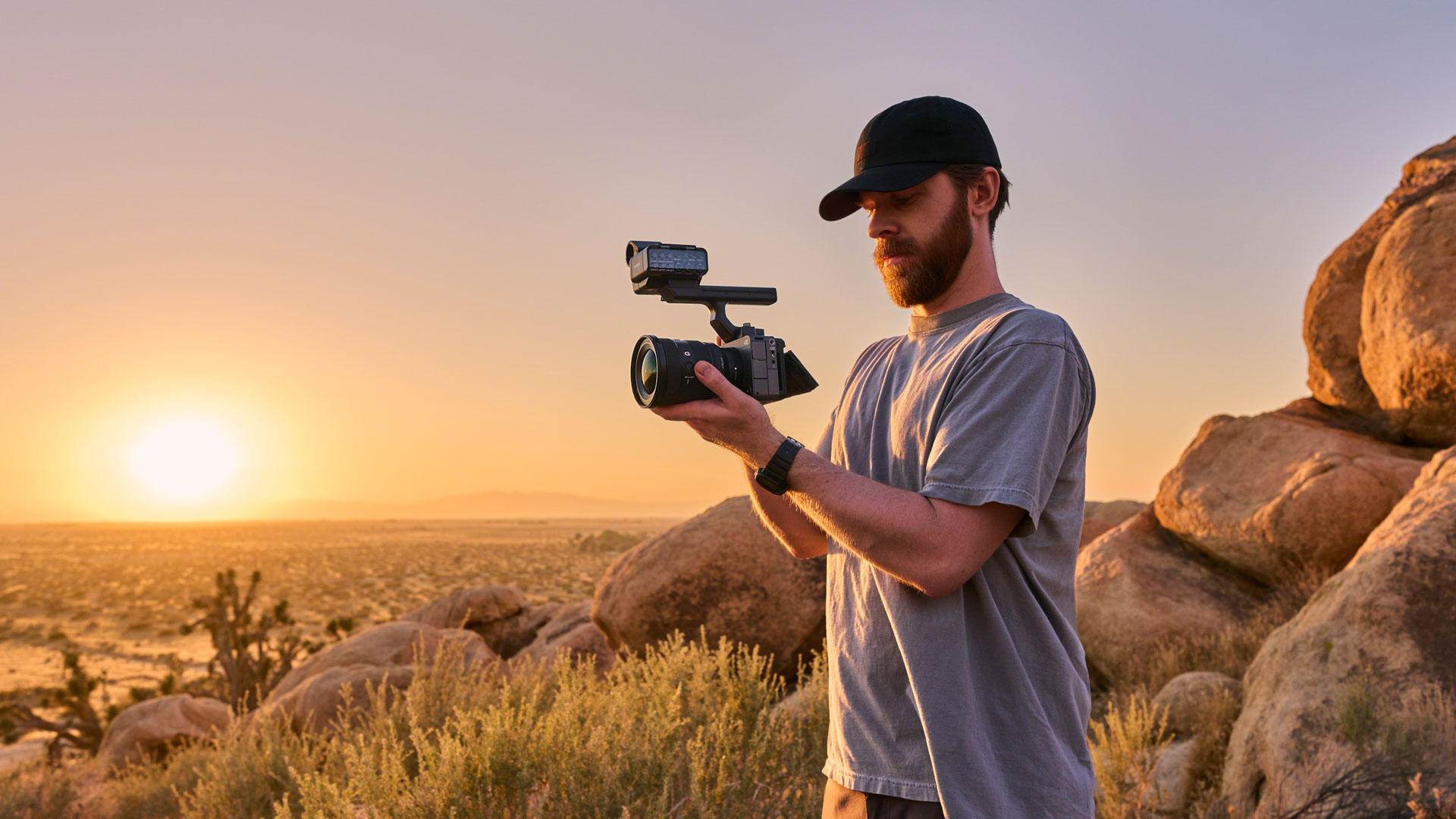 Sony FX5 with top handle attached, held by video recorder in a dry outdoor landscape during the golden hour