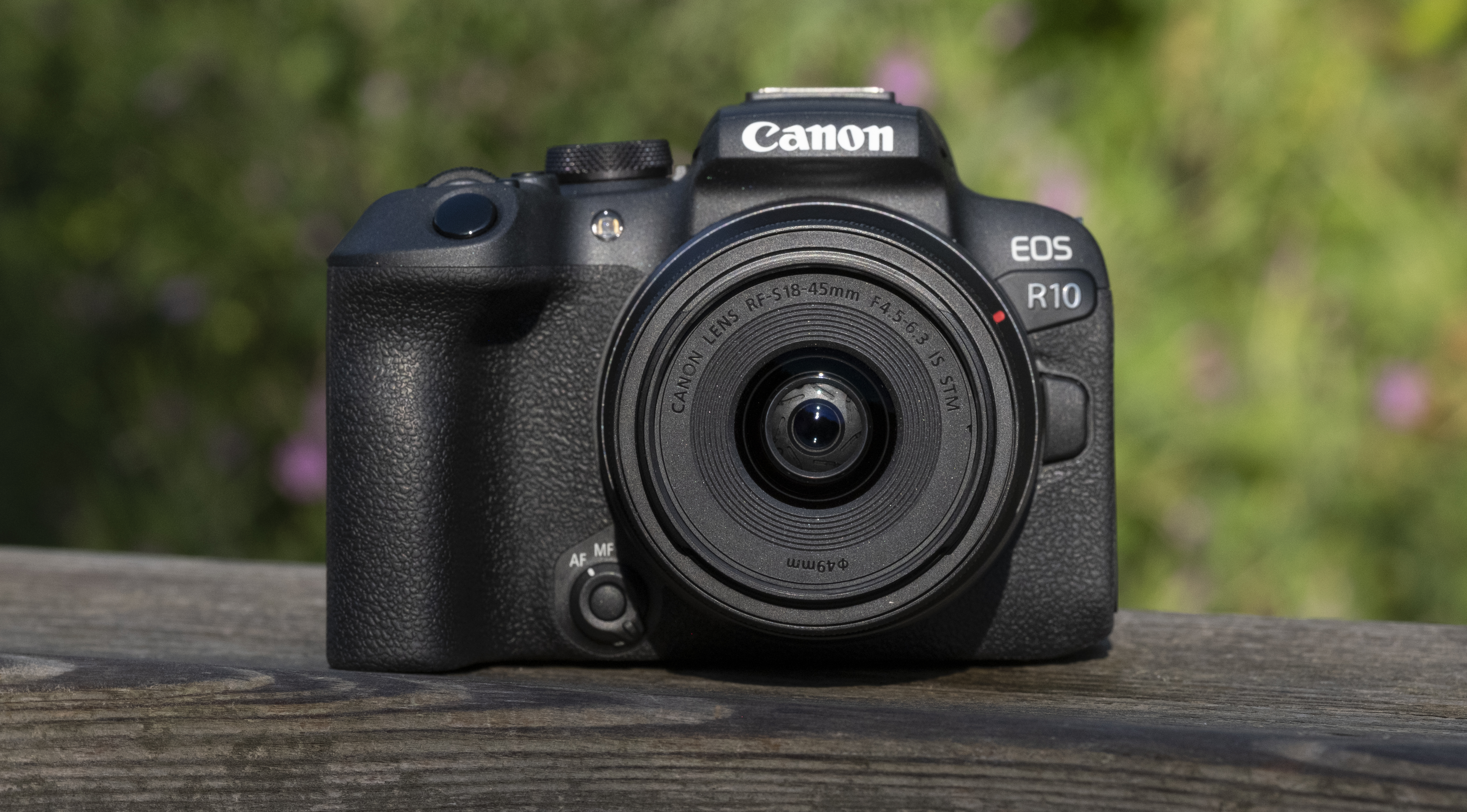 The Canon EOS R10 cameras sit on a wooden shelf