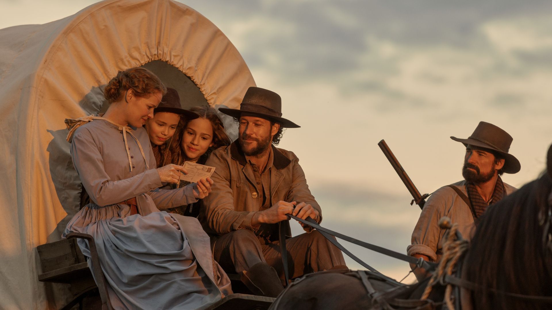 The Ingalls look at a letter while sitting in a carriage
