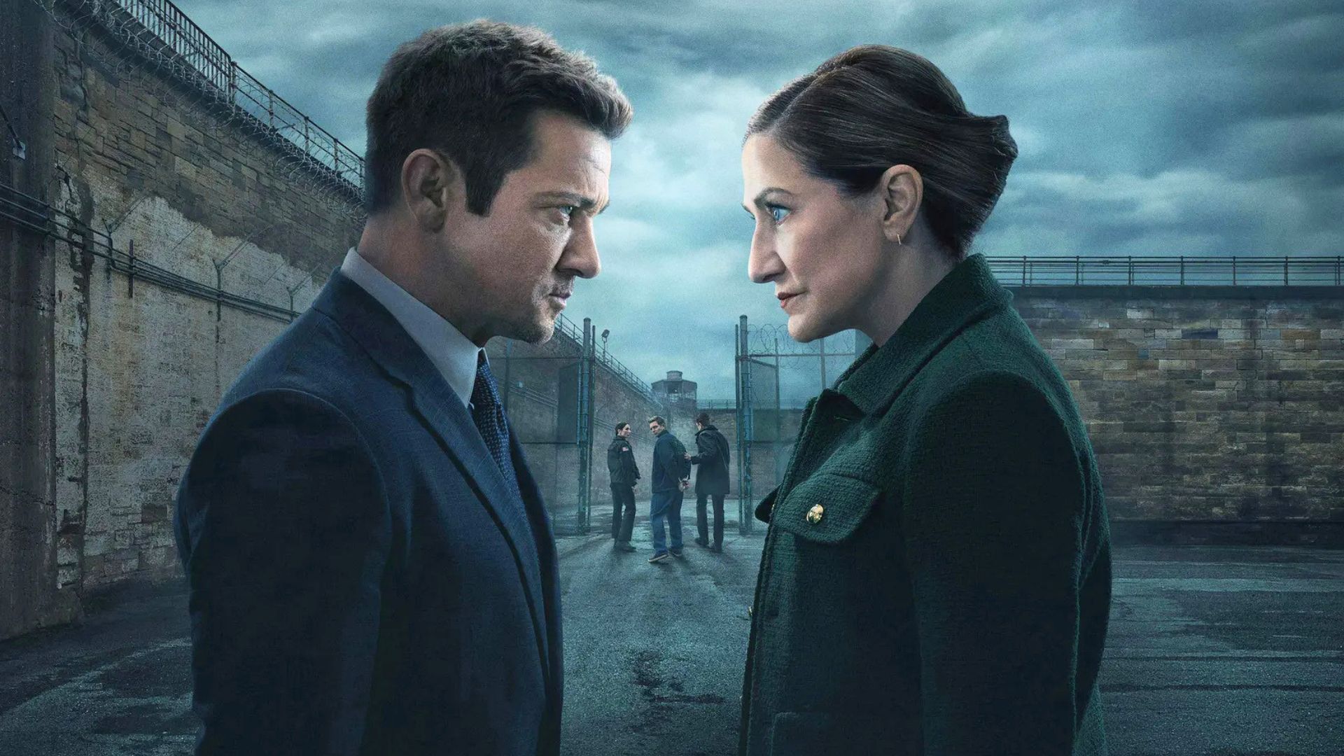 A man and a woman look at each other outside the prison gates