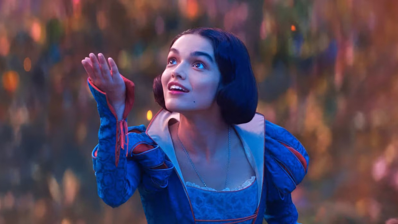 Rachel Zegler's Snow White holds up her right hand in her self-titled live-action adaptation