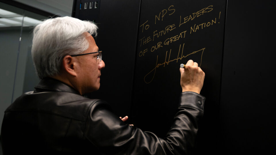 Nvidia CEO Jensen Huang signs the NVIDIA DGX GB300 AI supercomputer donated to the Naval Postgraduate School in Monterey, California.