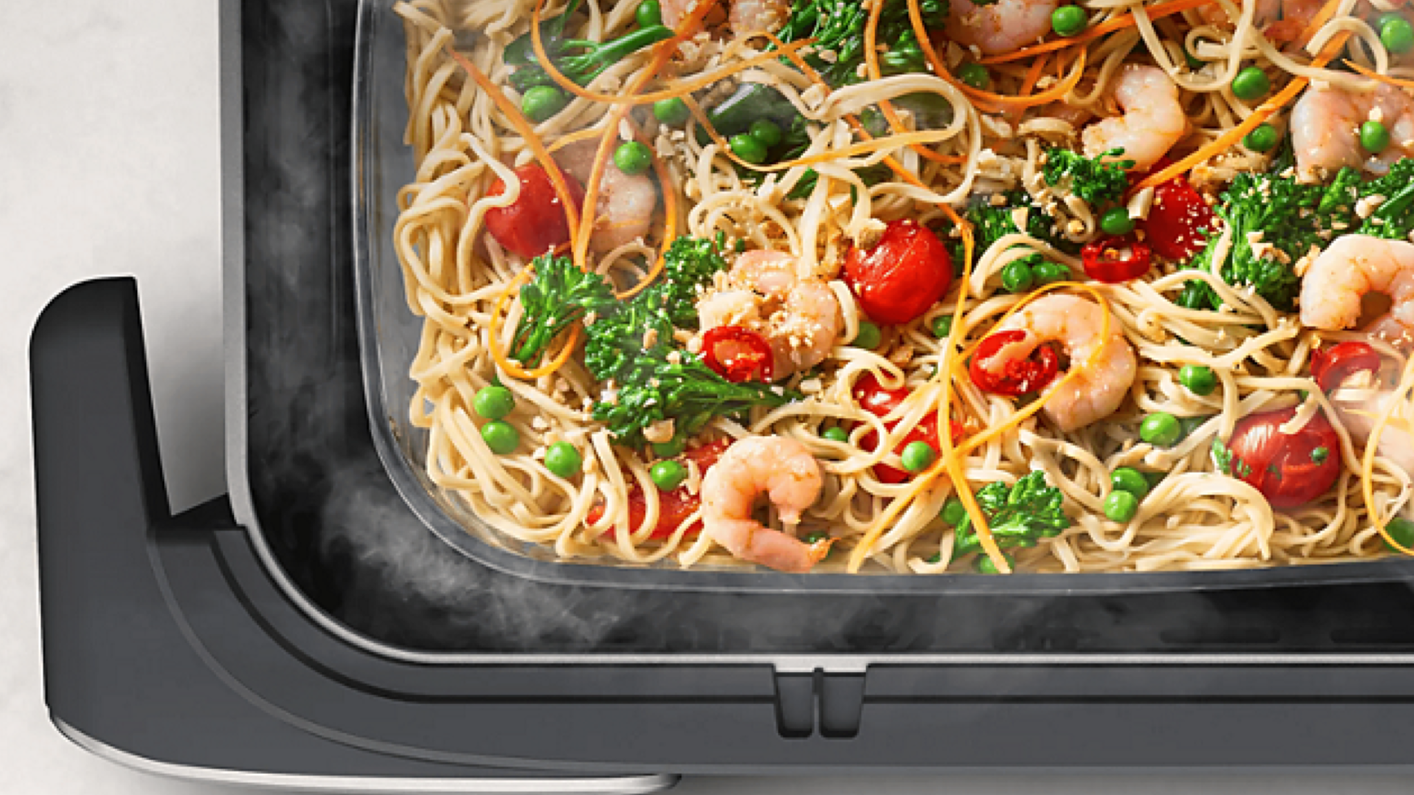 Product photo of Philips Airfryer 5000 Series Megabasket with steam shot from above showing food being steamed