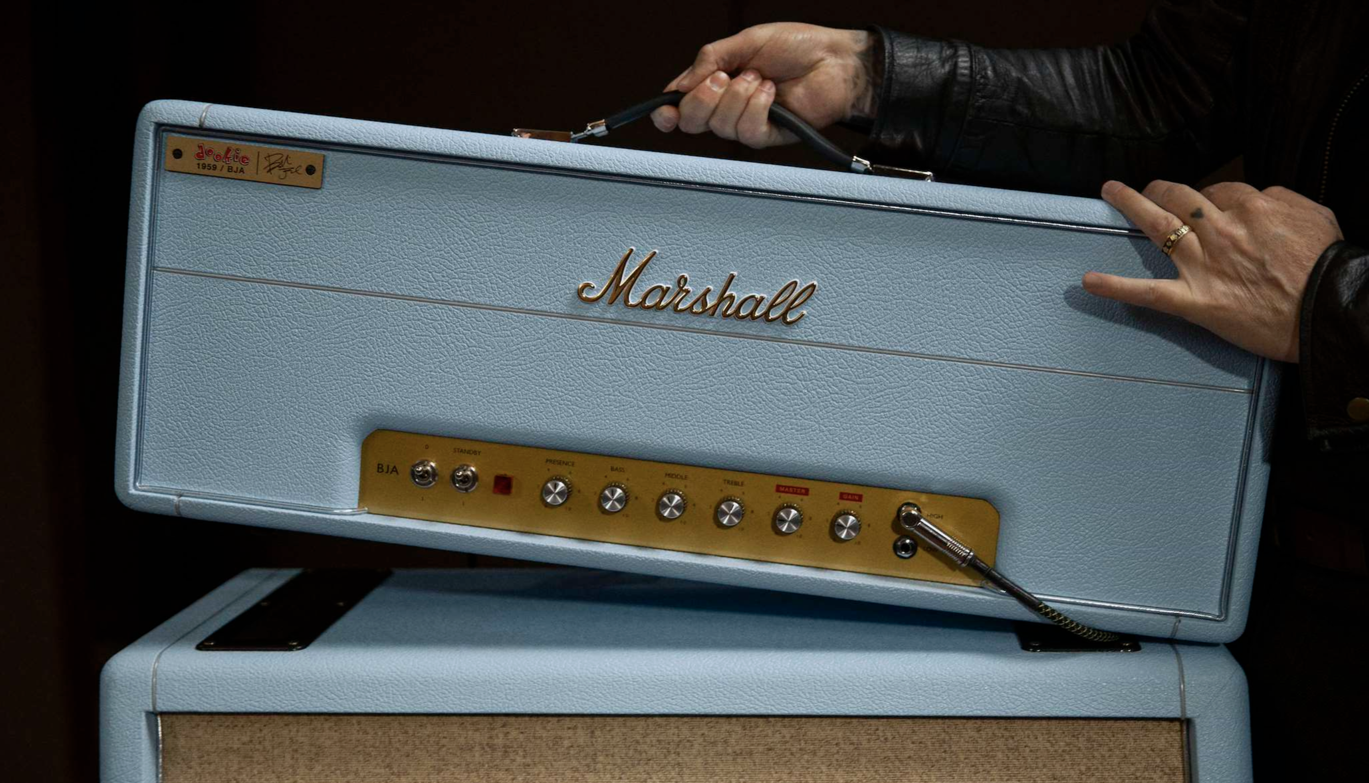 Marshall x Billie Joe Armstrong's baby blue guitar amp head, held by the star whose arms are just visible