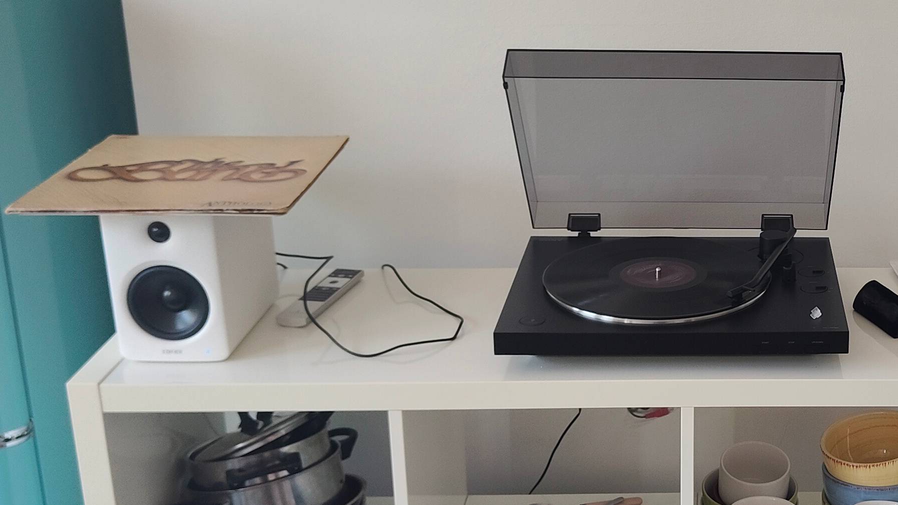 Sony PS-LX310BT and Edifier M90 on a shelf.